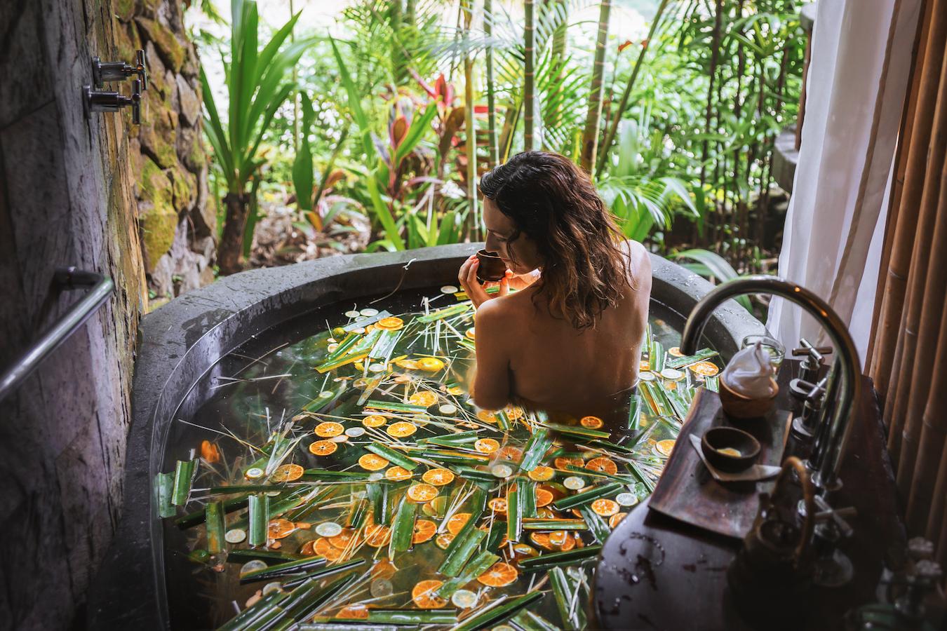 girl-bathing-in-water-with-plants-herbal-wellness