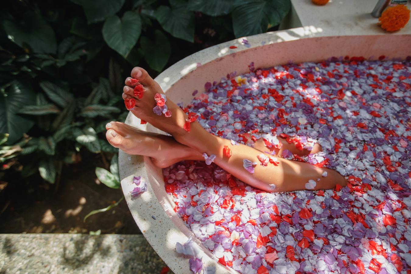 girl's-feet-in-bath-of-flower-petals-home-patient
